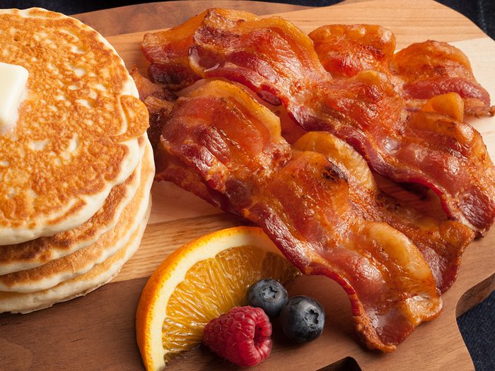 Bacon for breakfast with pancakes and berries