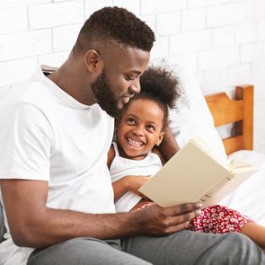 Benefits of reading out loud - man reading to daughter