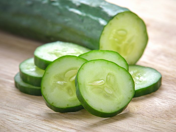 Bitter cucumber taste explaination - Fresh Cucumber slices on wood background