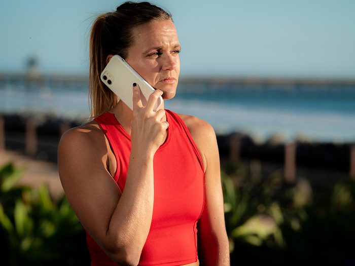 Concerned woman on phone at beach