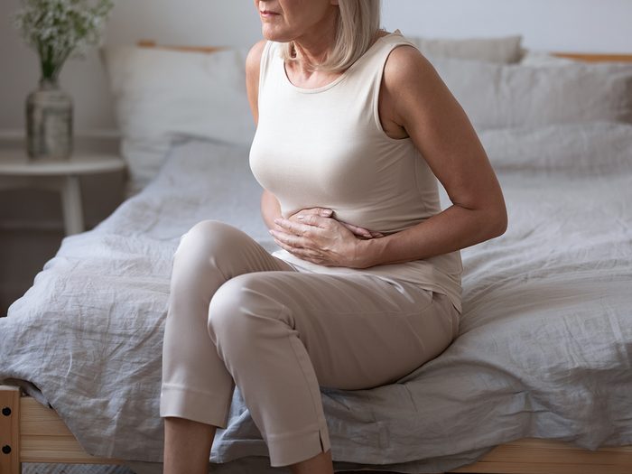 Liver problems - woman with upset stomach bloating