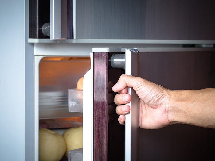 Man opening fridge door