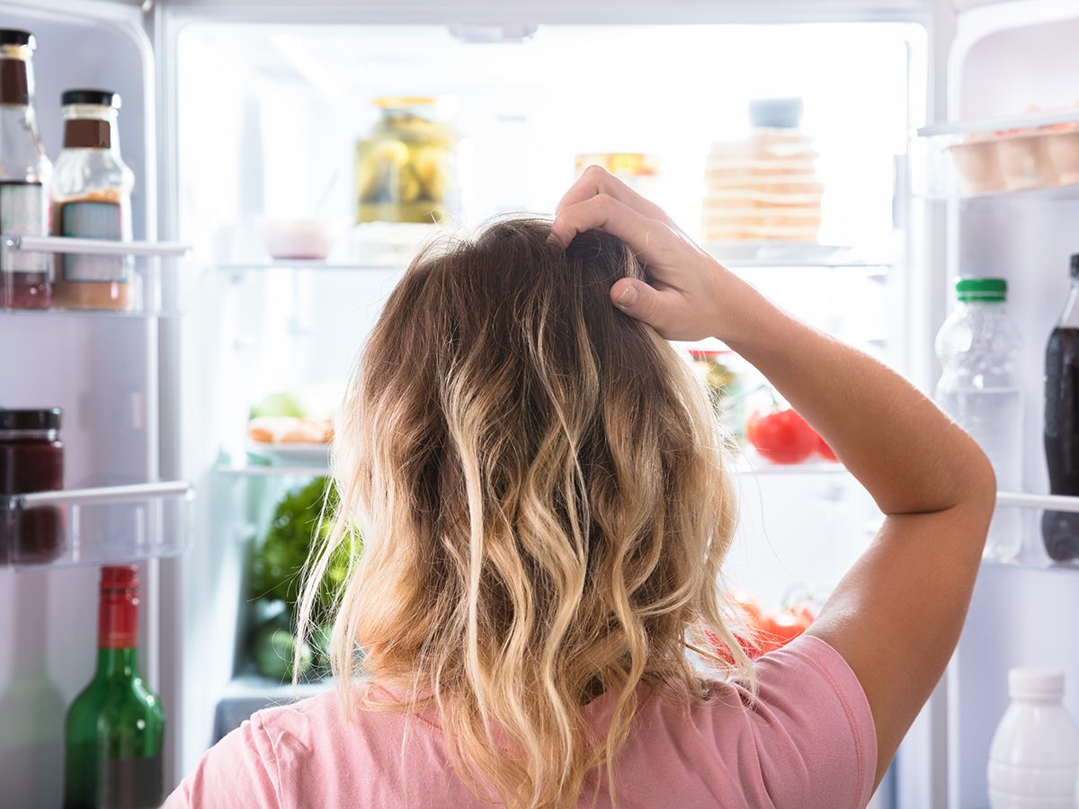 Signs your liver is struggling - confused woman looking at fridge