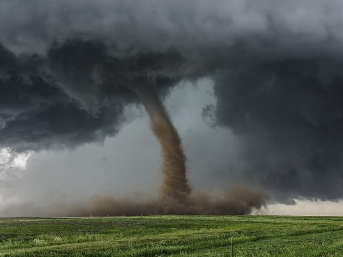 Tornado over green field