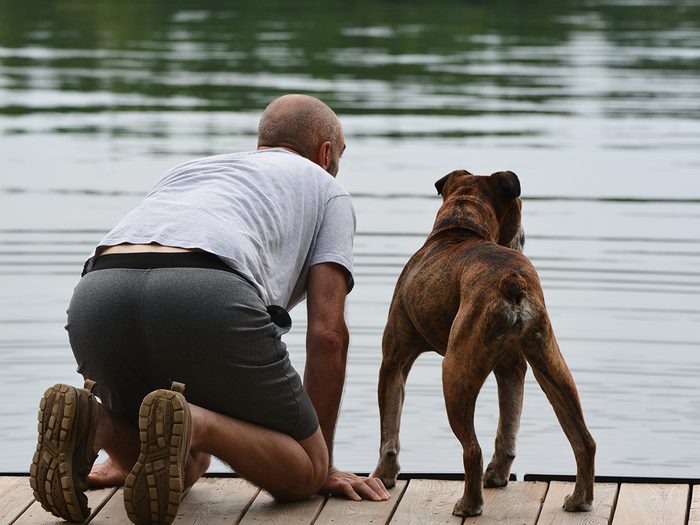 Candid photography - Man and dog on dock