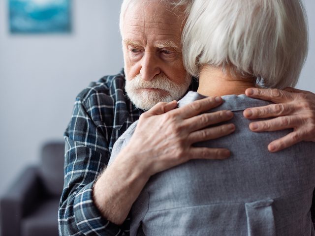 Early dementia symptoms - mature couple embracing
