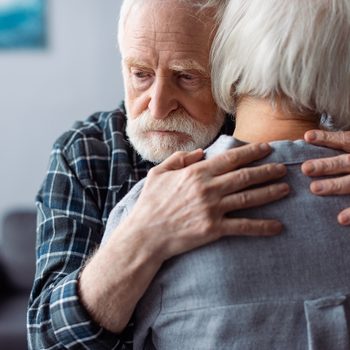 Early dementia symptoms - mature couple embracing
