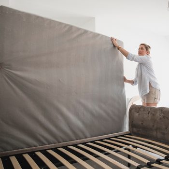 Flip your mattress - Mature couple are setting up their bed in their new home.