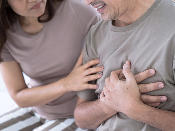 Heart attack symptoms - man clutching chest