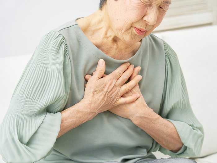 Heart attack symptoms - woman with chest pain