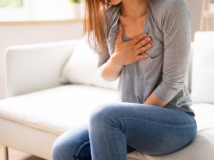 Heart attack symptoms - woman with chest discomfort