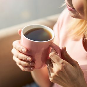 How much coffee is too much - woman drinking coffee from mug