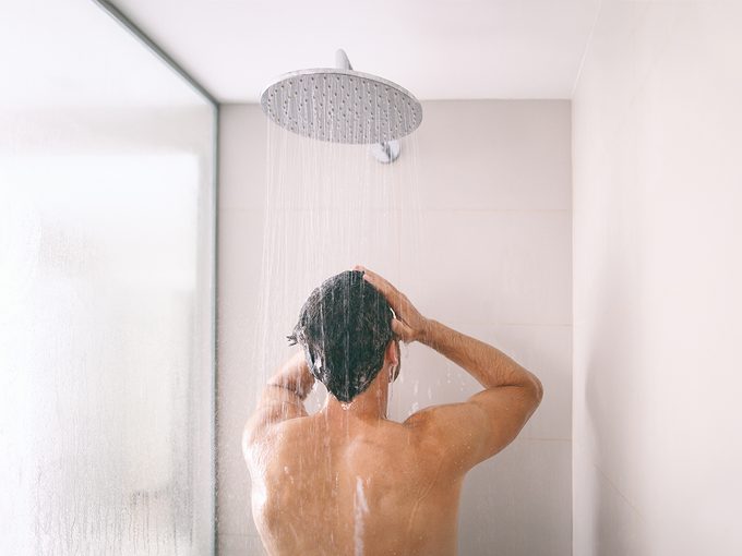 How often should you shower - Man in shower washing hair