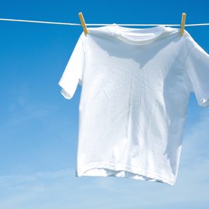 How to unshrink clothes - A plain white T-shirt hanging on a clothesline on a beautiful, sunny day