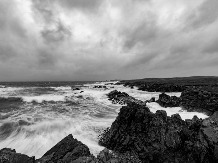 Natural disasters in Canada - hurricane reaching Newfoundland shore in black and white