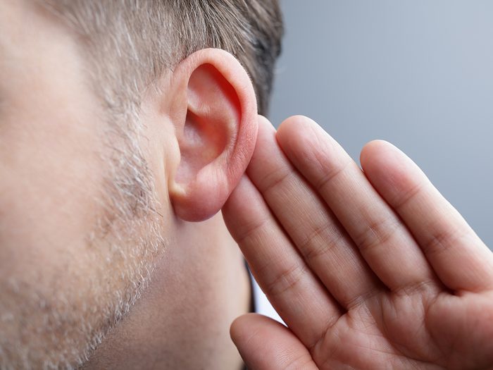Silent signs of hearing loss - man with hand to ear