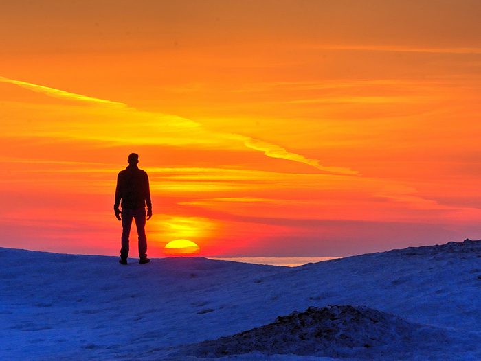 Sunset pictures - person standing silhouetted by sunset