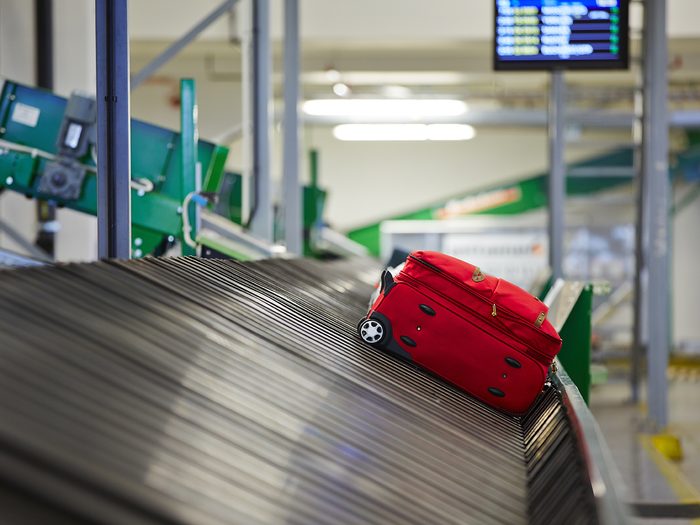 Travel mistakes - luggage on conveyor at airport