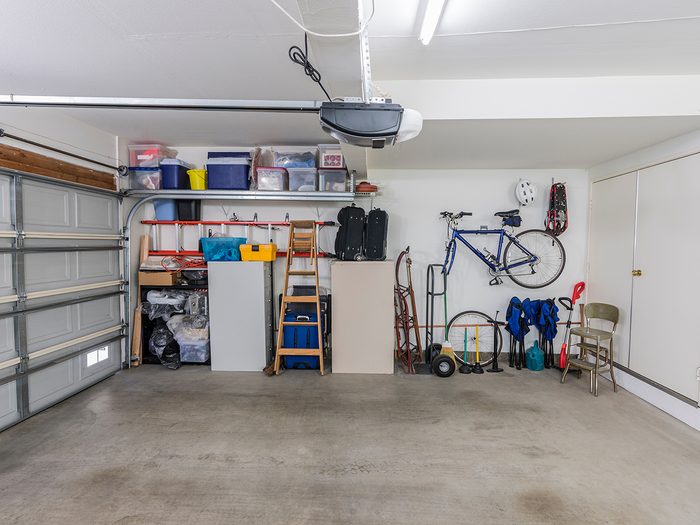 Organized clean suburban residential two car garage with tools, file cabinets and sports equipment.