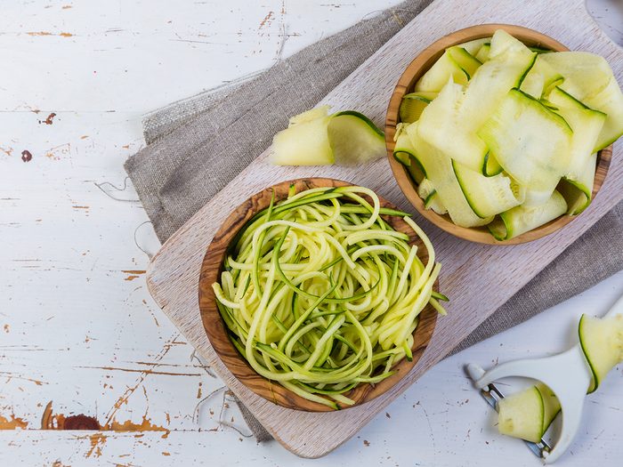 Best vegetables for weight loss - raw zucchini pasta on white background
