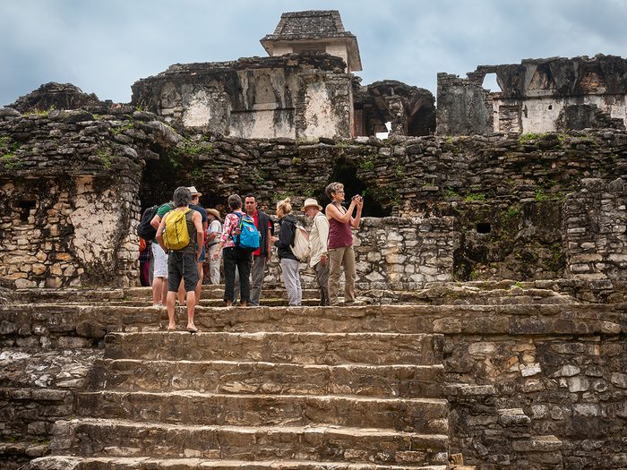 Budget travel tips - tour group exploring Mexico ruins
