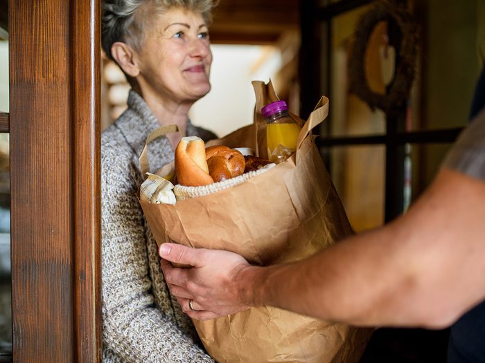 Delivering groceries to mature woman
