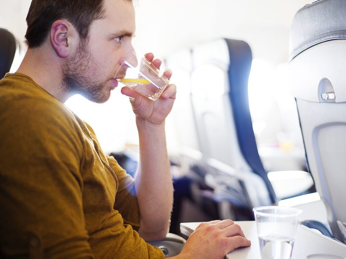 Man drinking on plane