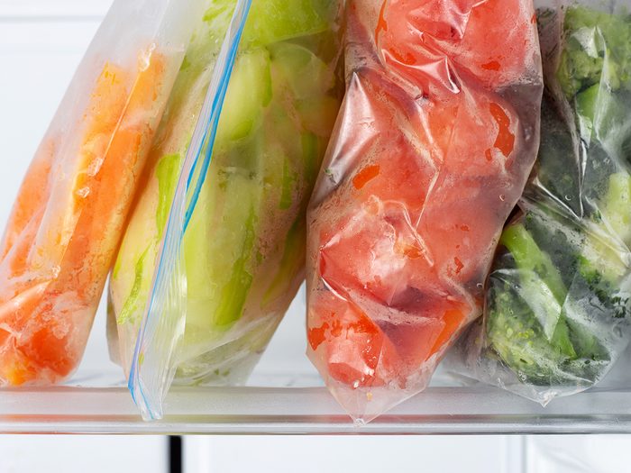 Things in your freezer you should toss - Frozen vegetables in plastic bags in the freezer close-up.