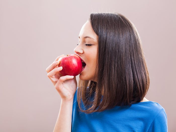 Bloated all the time - woman eating apple
