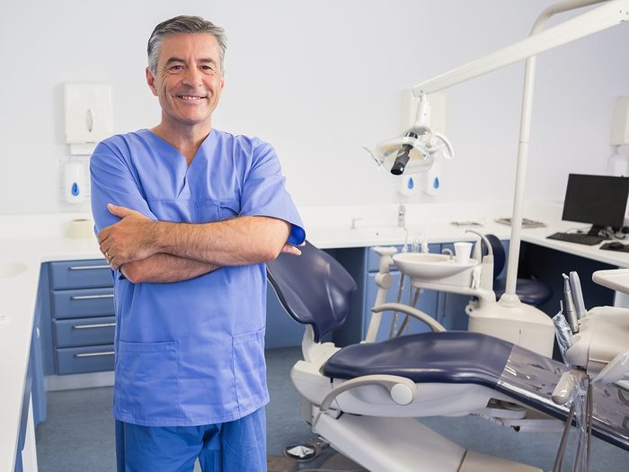 Canadian dental facts - dentist beside chair