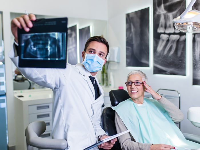 Canadian dental facts - dentist reviewing x-rays with patient