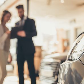 Car dealer tricks - woman buying car at dealership