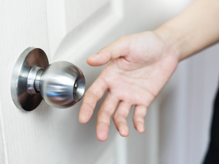 House fire facts - hand reaching for doorknob