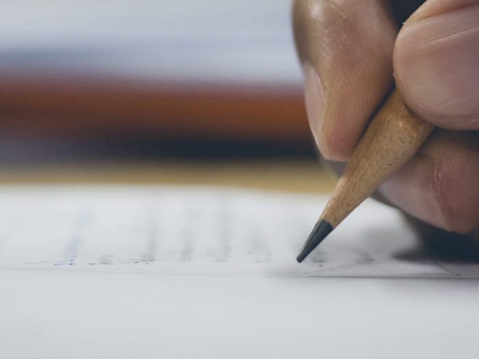 Man writing note in pencil