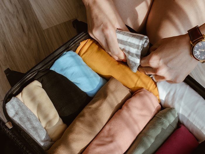 Small space storage - rolled clothes stored in suitcase