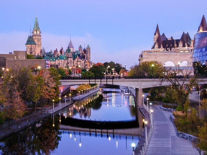 Unesco World Heritage Sites Canada - Rideau Canal in Ottawa, with Parliament and Chateau Laurier in view at dusk. Rideau Canal National Historic Site