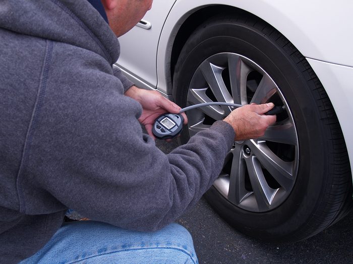 Man checking tire pressure