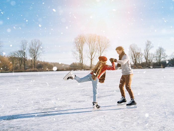 Couple skating on frozen pond