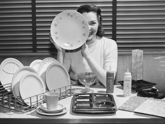 Happy woman holding plate - vintage photo