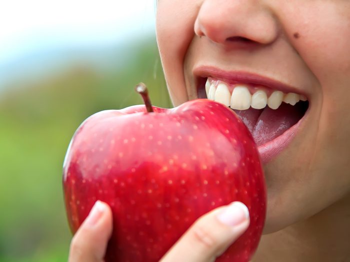 How to eat less - woman eating apple