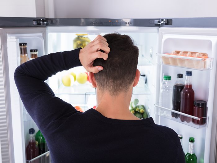 Hungry man looking in fridge