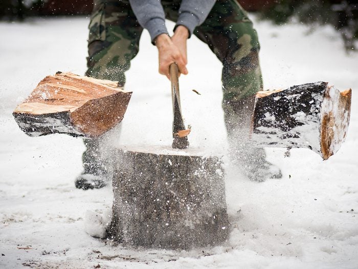 Man chopping wood in winter