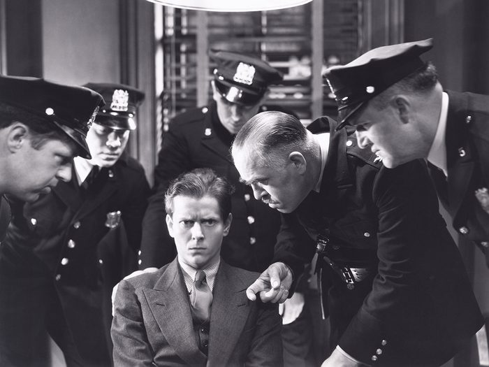 Man being questioned by police - vintage photo