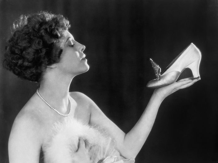 Woman admiring shoe - vintage photo