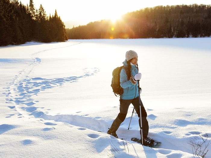 Woman in snowshoes on hike through wilderness