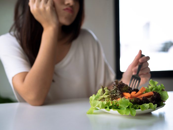 Woman not hungry for salad