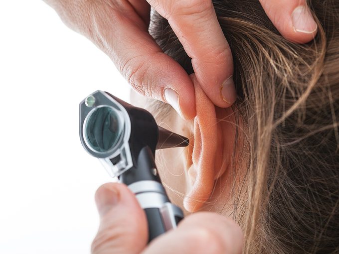 Ear wax colour - doctor examining patient's ear