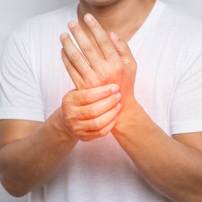 Shark cartilage for arthritis relief - man holding arthritic hand