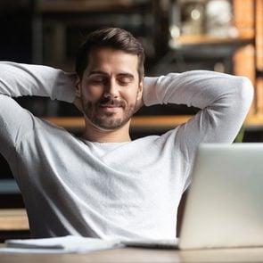 Benefits of meditation - relaxed man working on laptop