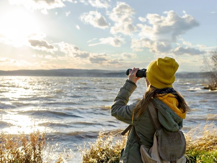 A woman with binoculars going birdwatching 